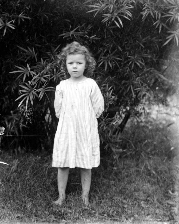 Young barefoot girl standing